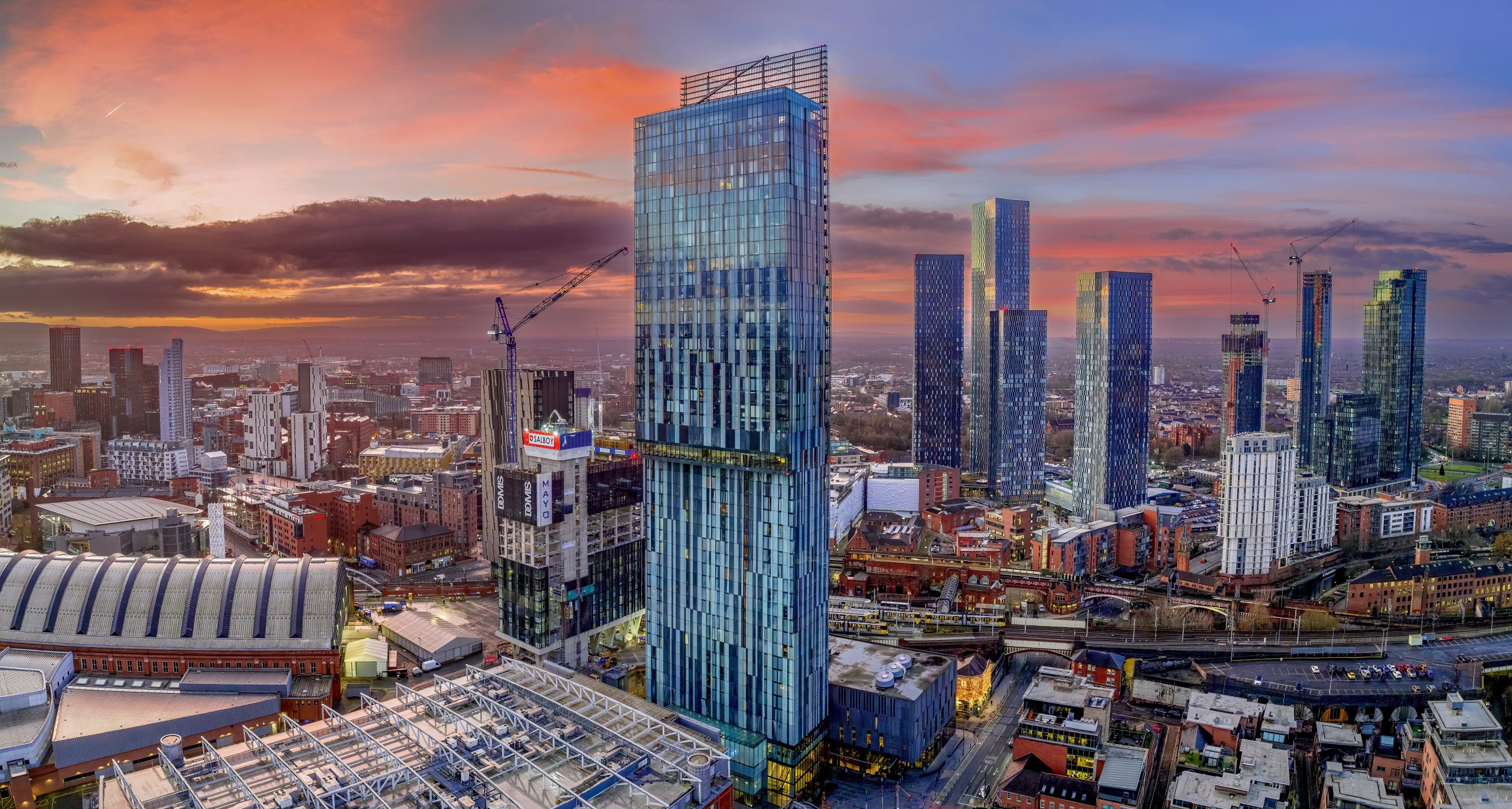 Manchester City centre Aerial night view of Deansgate Square and Beetham Tower Manchester northern England. City Centre at sunrise with coloured sky Manchester City centre Aerial night view of Deansgate Square and Beetham Tower Manchester northern England. City Centre at sunrise with coloured sky