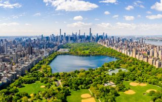 Central Park aerial view, Manhattan, New York. Park is surrounded by skyscraper. Beautiful view of the Jacqueline Kennedy Onassis Reservoir in the center of the park.