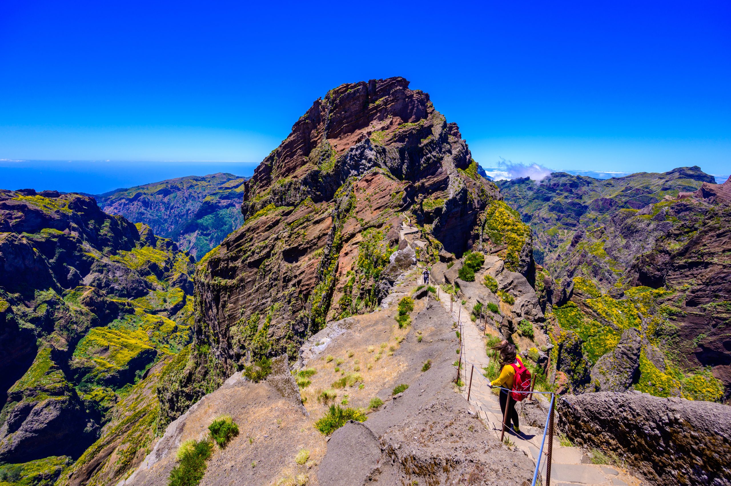 Beautiful hiking trail from Pico do Arieiro to Pico Ruivo, Madeira island. Footpath PR1 – Vereda do Areeiro. On summy summer day above the clouds. Portugal.