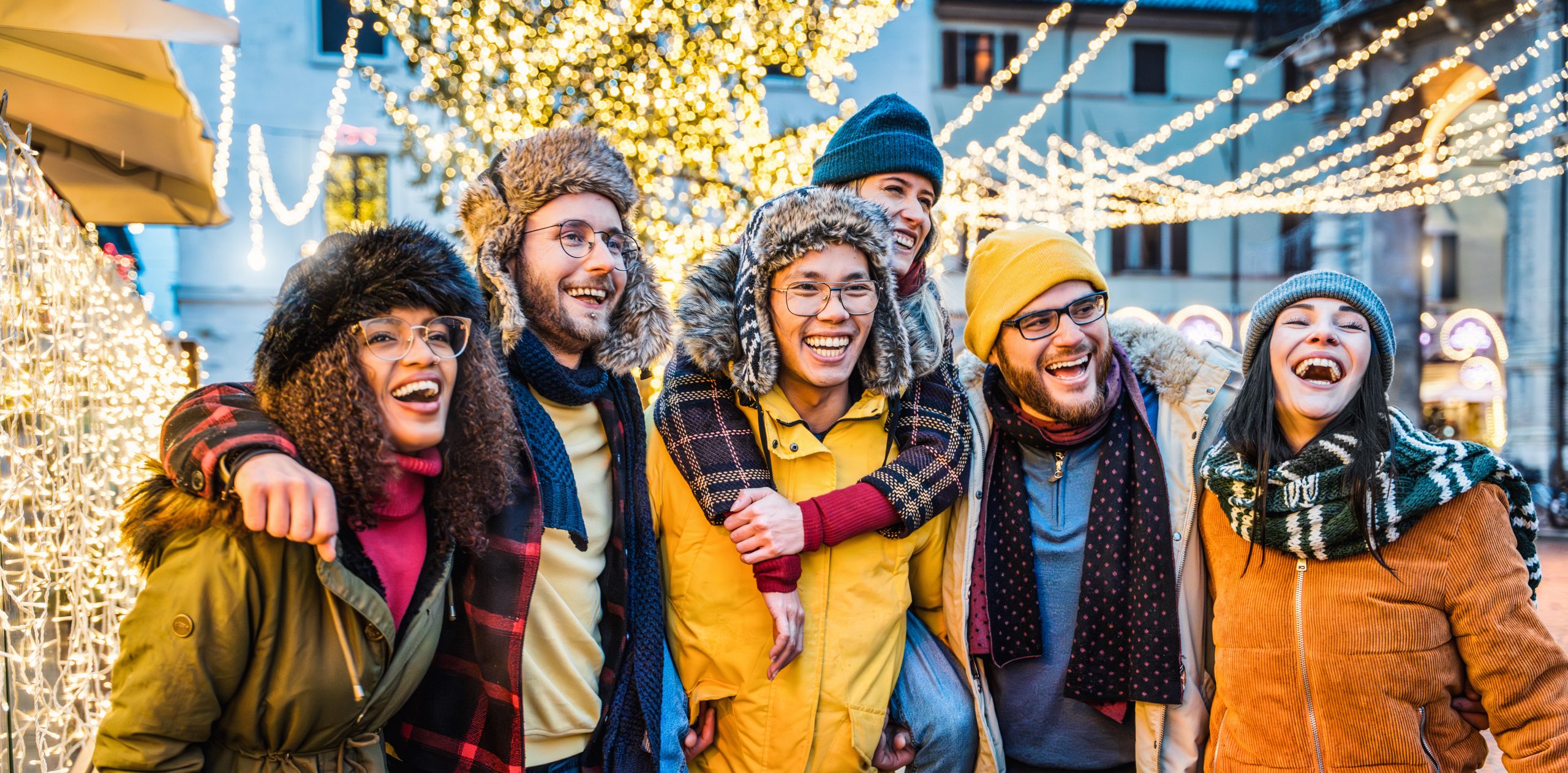 Happy friends having fun enjoying Christmas day in city street – Group of young people celebrating new year event outside – Winter holidays life style concept