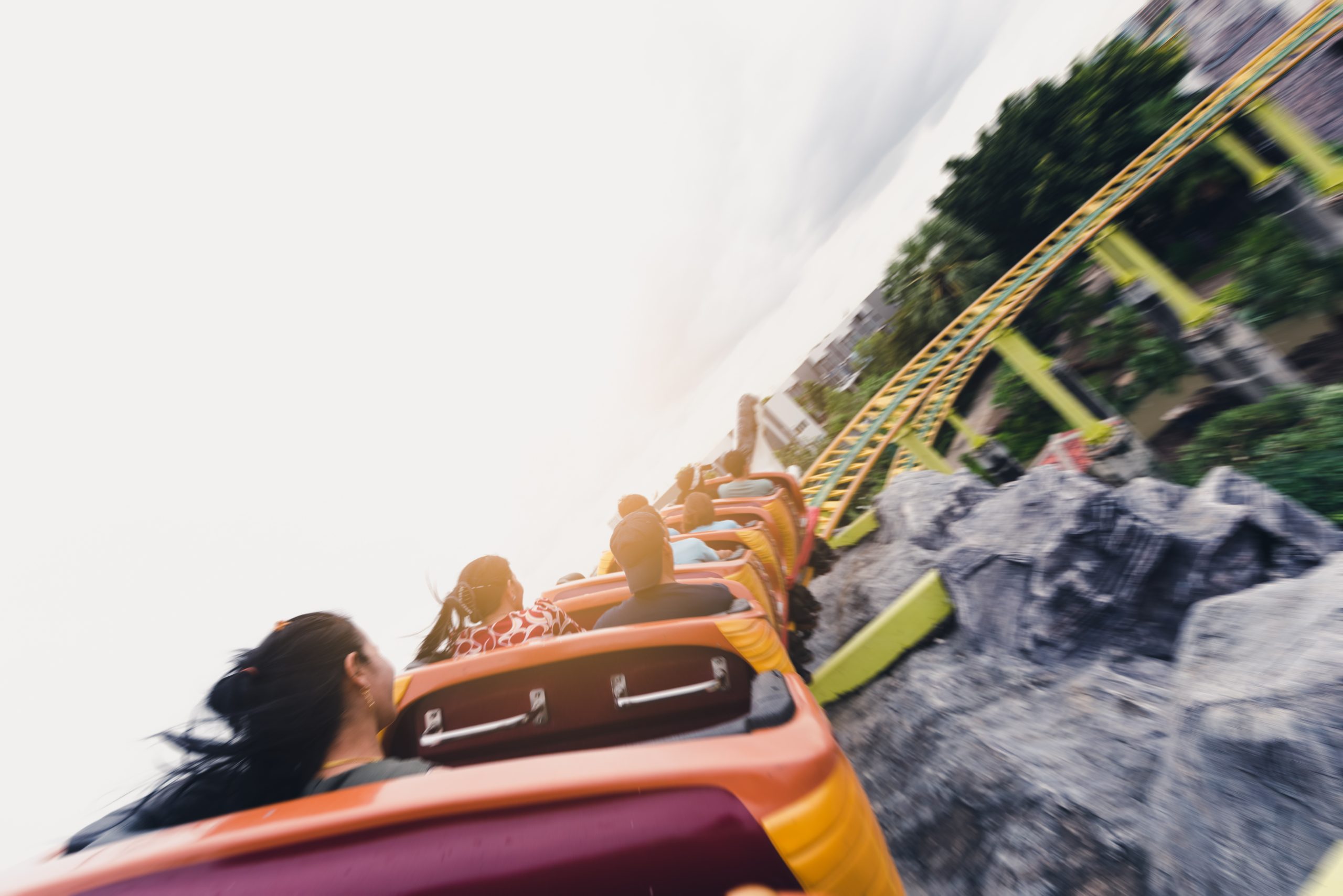 the abstract image of the roller coaster running on the rail in amusement park. the concept of extreme, fun, holiday and vacation.